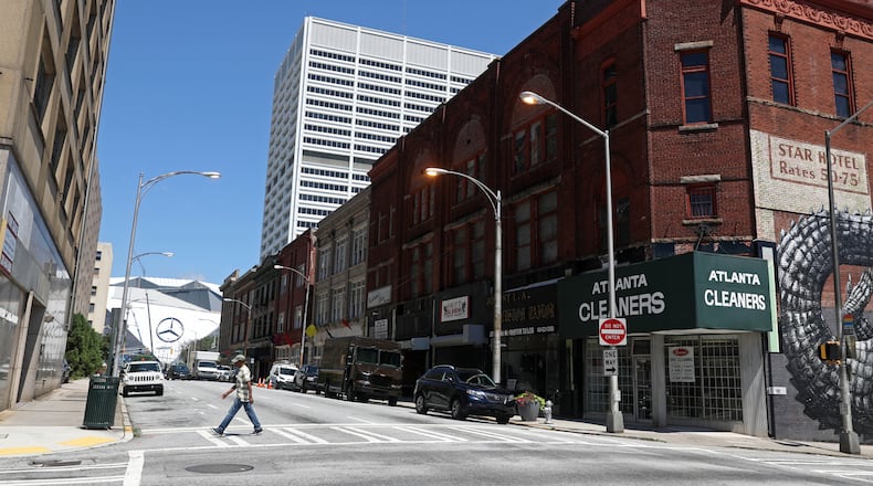 June 26, 2016 - Atlanta, Ga: The Mercedes-Benz stadium is shown in the distance along Mitchell street Monday, June 26, 2016, in Atlanta, Ga.. Newport US, a German-backed development firm, has recently acquired buildings stretching over several blocks of downtown Atlanta, including some on Mitchell Street. PHOTO / JASON GETZ