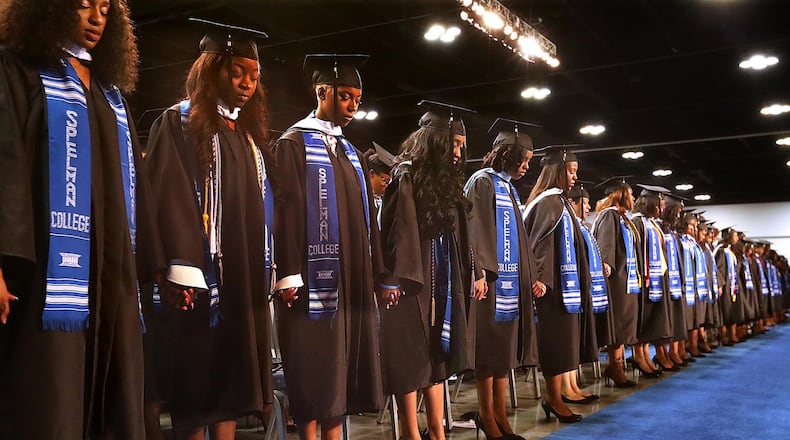 May 21, 2017, College Park: Graduates join hands for an opening prayer during the Spelman College 2017 Commencement Ceremony at the Georgia International Convention Center on Sunday, May 21, 2017, in College Park.     Curtis Compton/ccompton@ajc.com