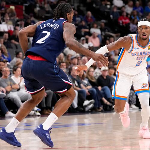Oklahoma City Thunder guard Shai Gilgeous-Alexander, right, tries to get past Los Angeles Clippers forward Kawhi Leonard during the first half of an NBA basketball game Wednesday, April 8, 2026, in Inglewood, Calif. (AP Photo/Mark J. Terrill)