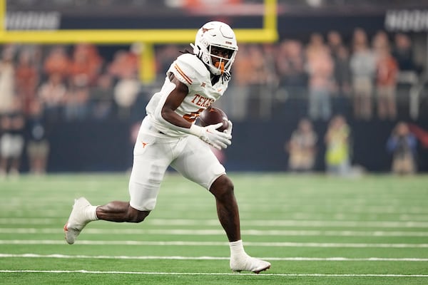 FILE - Texas running back CJ Baxter (4) runs the ball during the Big 12 Conference championship NCAA college football game against Oklahoma State in Arlington, Texas, Saturday, Dec. 2, 2023. (AP Photo/Tony Gutierrez, File)