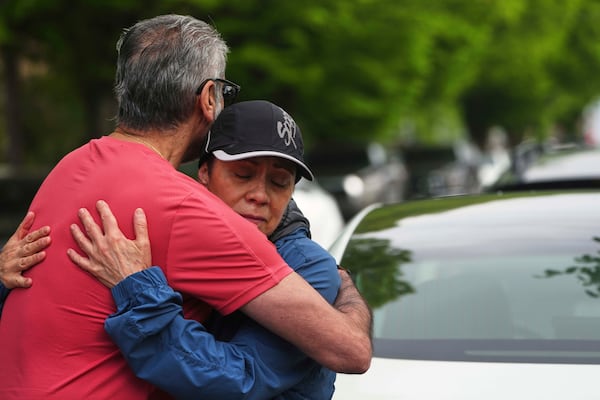 Esperanza Bermudez, facing, who lives across the street from the scene, is comforted by friends Manjit Claire, left, the morning after a driver killed multiple people during a Filipino community festival Sunday, April 27, 2025, in Vancouver, British Columbia. (AP Photo/Lindsey Wasson)