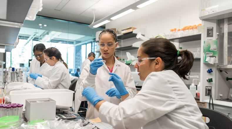 Researchers work in the cell manufacturing laboratory of Krishnendu Roy at Georgia Tech. Shown (l-r) are NSF Graduate Research Fellow Joscelyn Mejias, Research Experience for Undergraduates (REU) Program student Angela Jimenez, (background) Postdoctoral Fellow Randall Toy, Georgia Tech Research Institute TAG-Ed High School Intern Gita Balakirsky, and Project ENGAGES High School Intern Ayanna Prather. PHOTO CONTRIBUTED
