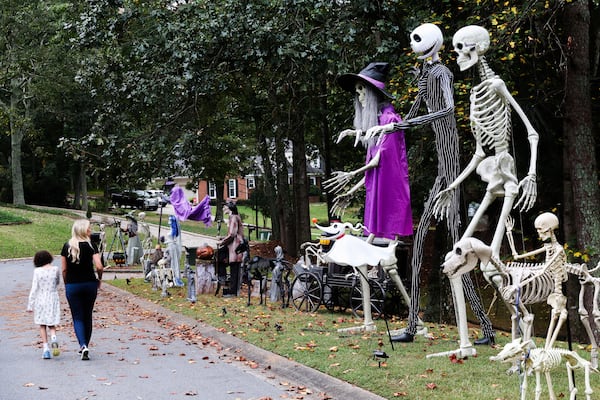 Kathleen Ridley and her daughter, Harper, walk along their Halloween display at their Cumming home on Thursday, Sept. 25, 2025. (Abbey Cutrer/AJC) 