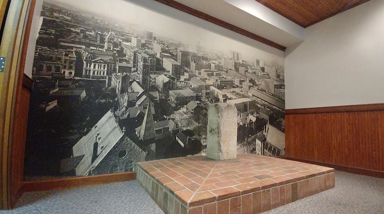 The Zero Mile Post, seen here on April 19, 2018 has been in place since 1850 and marks the terminus of the first rail line built to the place that would become Atlanta. A building was constructed around the post in the 1980s, protecting the landmark and creating a sort of mini-museum. That building is now slated for demolition in late 2018 or early 2019. A large poster image of downtown Atlanta in the early 20th century serves as a backdrop. (William Thweatt / wthweatt@ajc.com)