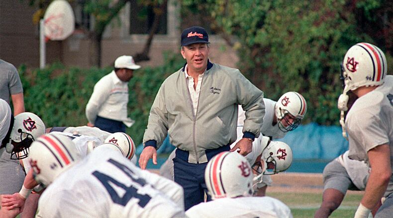 FILE - In this Dec. 27, 1988, file photo, Auburn football coach Pat Dye walks through his players as they begin workouts in preparation for the Sugar Bowl in New Orleans. Former Auburn coach Pat Dye, who took over a downtrodden football program in 1981 and turned it into a Southeastern Conference power, has died. He was 80. Lee County Coroner Bill Harris said Dye passed away Monday, June 1, 2020, at the Compassus Bethany House in Auburn, Ala.(AP Photo/Bill Haber, FIle)