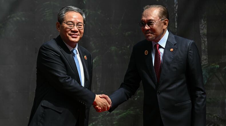 China's Premier Li Qiang, left, shakes hands with Malaysia's Prime Minister Anwar Ibrahim as he arrives at the Kuala Lumpur Convention Centre to attend the 47th Association of Southeast Asian Nations (ASEAN) summit in Kuala Lumpur, Malaysia, Monday, Oct. 27, 2025. (Lillian Suwanrumpha/Pool Photo via AP)