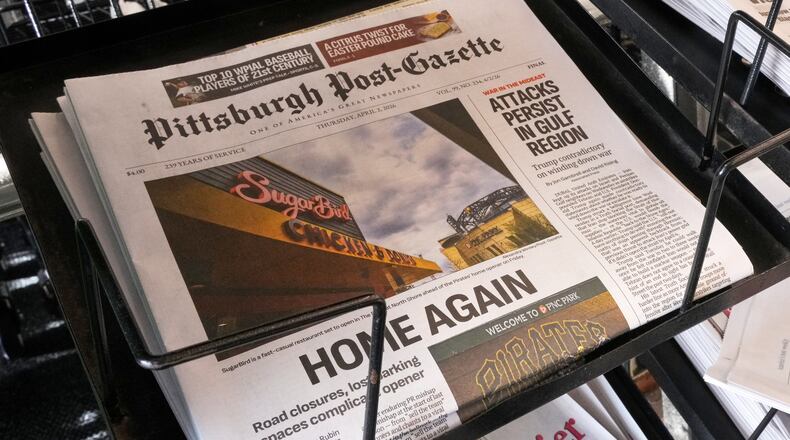 The printed edition of the Pittsburgh Post-Gazette sits in a newspaper rack, Thursday, April 2, 2026, in Pittsburgh. (AP Photo/Gene J. Puskar)