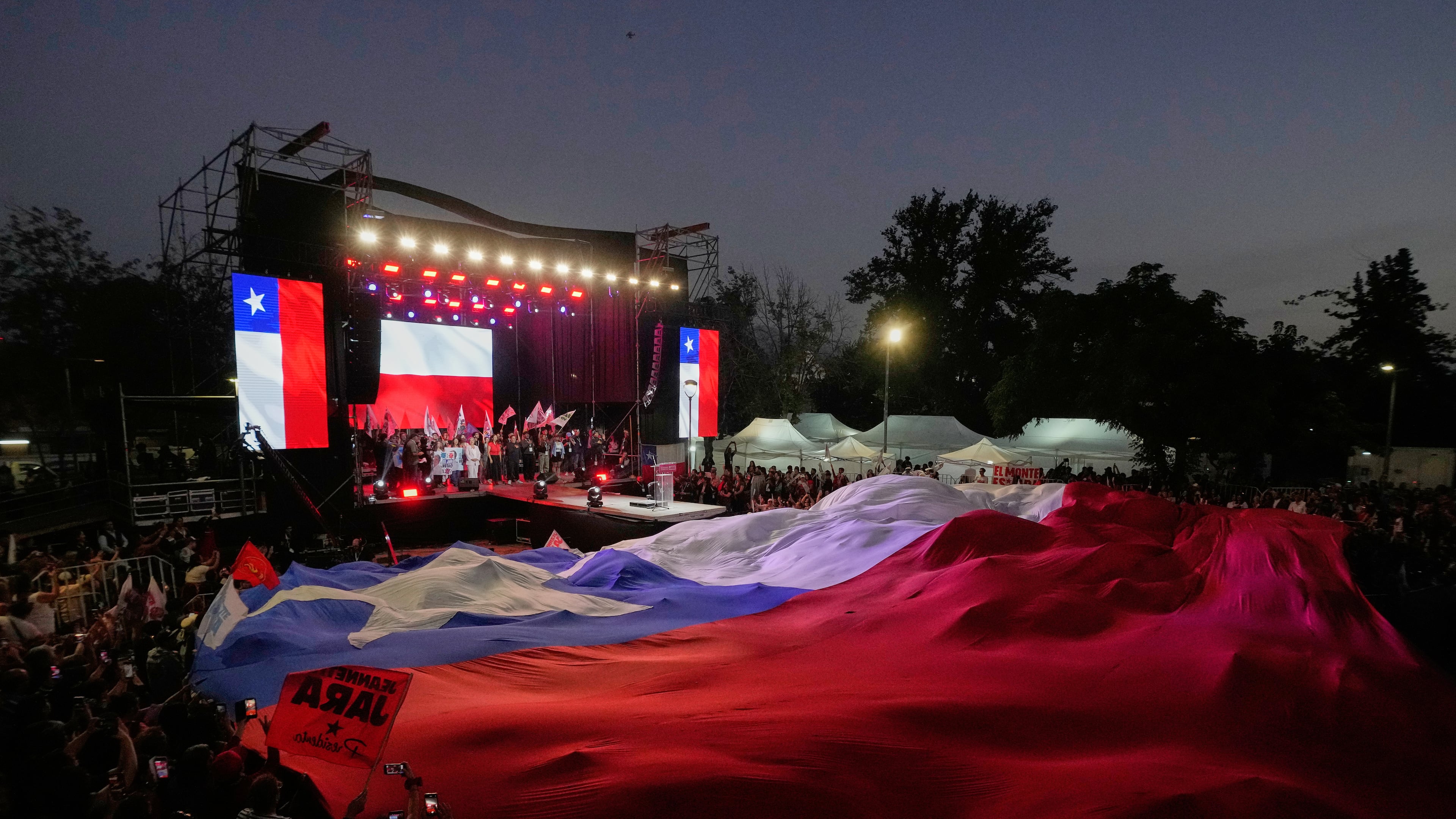 Supporters of Presidential candidate Jeannette Jara of the Unidad por Chile coalition attend a rally ahead of the presidential runoff election in Santiago, Chile, Wednesday, Dec. 10, 2025. (AP Photo/Esteban Felix)