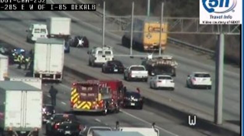 Authorities are investigating a crash that involved a police officer and led to injuries Friday in DeKalb County on I-285 west. (Credit: Channel 2 Action News)