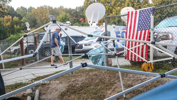 Several media outlets have closed up shop outside the Fulton County Jail on Rice Street in the aftermath of former President Donald Trump's surrender Friday, Aug. 25, 2023. (John Spink / John.Spink@ajc.com)