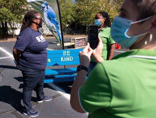 Dione Simon Taylor, principal of Harper-Archer Elementary School in  Atlanta, left, is interviewed by Katrina Reed, school partnerships manager with Out Teach, on Oct. 13, 2020, for a Facebook Live post during an event where volunteers dropped off projects they built for an outdoor learning lab at the school. (Ben Gray for the Atlanta Journal-Constitution)