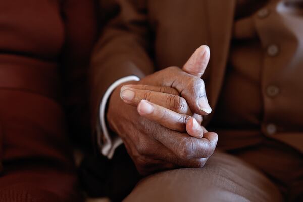 Betty and Glenn Madison hold hands at their home in McDonough on Thursday, Feb. 12, 2026. The couple met in 1957 and have been married for 65 years. (Natrice Miller/AJC)