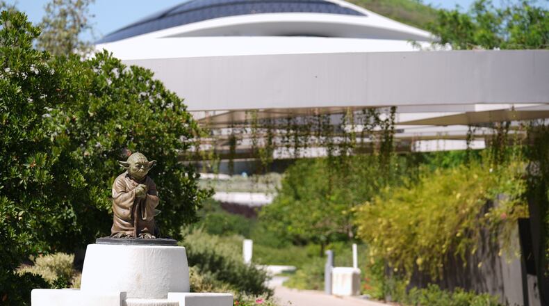 A sculpture of the "Star Wars" character Yoda is displayed along a walking path in the garden area of the the Lucas Museum of Narrative Art during a preview of the museum on Monday, Aug. 31, 2026, in Los Angeles. (AP Photo/Chris Pizzello)