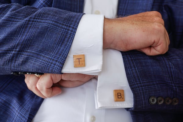 Timothy Batten, an arbitrator and mediator at JAMS in Atlanta, shows off his Scrabble tile cufflinks. He has stepped out of the spotlight since retiring as a federal judge in the Northern District of Georgia. (Natrice Miller/AJC)