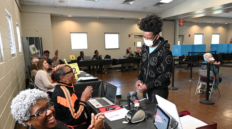 October 22, 2022 Stone Mountain - First time voter Channing Settles, 18, is recognized by poll workers at an early voting location in Mountain Park Activity Building in Stone Mountain on Saturday, October 22, 2022. A record-breaking week of early voting continues Saturday, the first weekend voting day of the general election season. Some 729,029 people cast ballots Monday through Friday, far surpassing the 488,177 people voted during the same period in the 2018 midterm election. (Hyosub Shin / Hyosub.Shin@ajc.com)