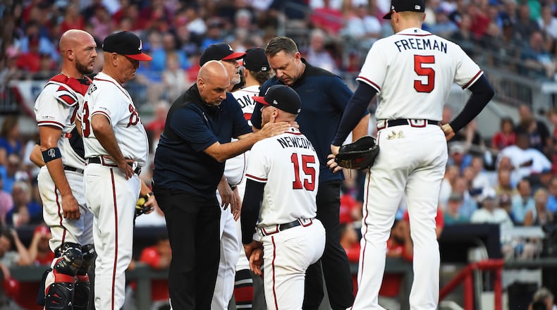 The Braves’ Sean Newcomb is attended to by training staff after being hit by a line drive during a game against the Philadelphia Phillies at SunTrust Park on Saturday.