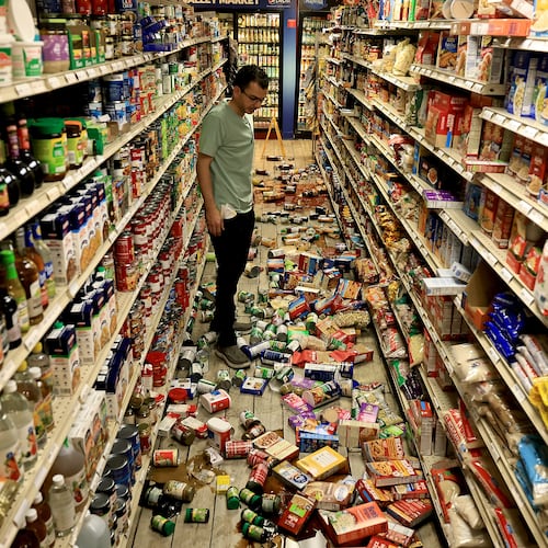 Redwood Valley Market owner Alex Chehada looks at items which fell off the shelves after an earthquake in Redwood Valley, Calif., Wednesday, June 24, 2026. (Kent Porter/The Press Democrat via AP)
