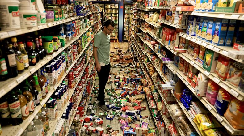 Redwood Valley Market owner Alex Chehada looks at items which fell off the shelves after an earthquake in Redwood Valley, Calif., Wednesday, June 24, 2026. (Kent Porter/The Press Democrat via AP)