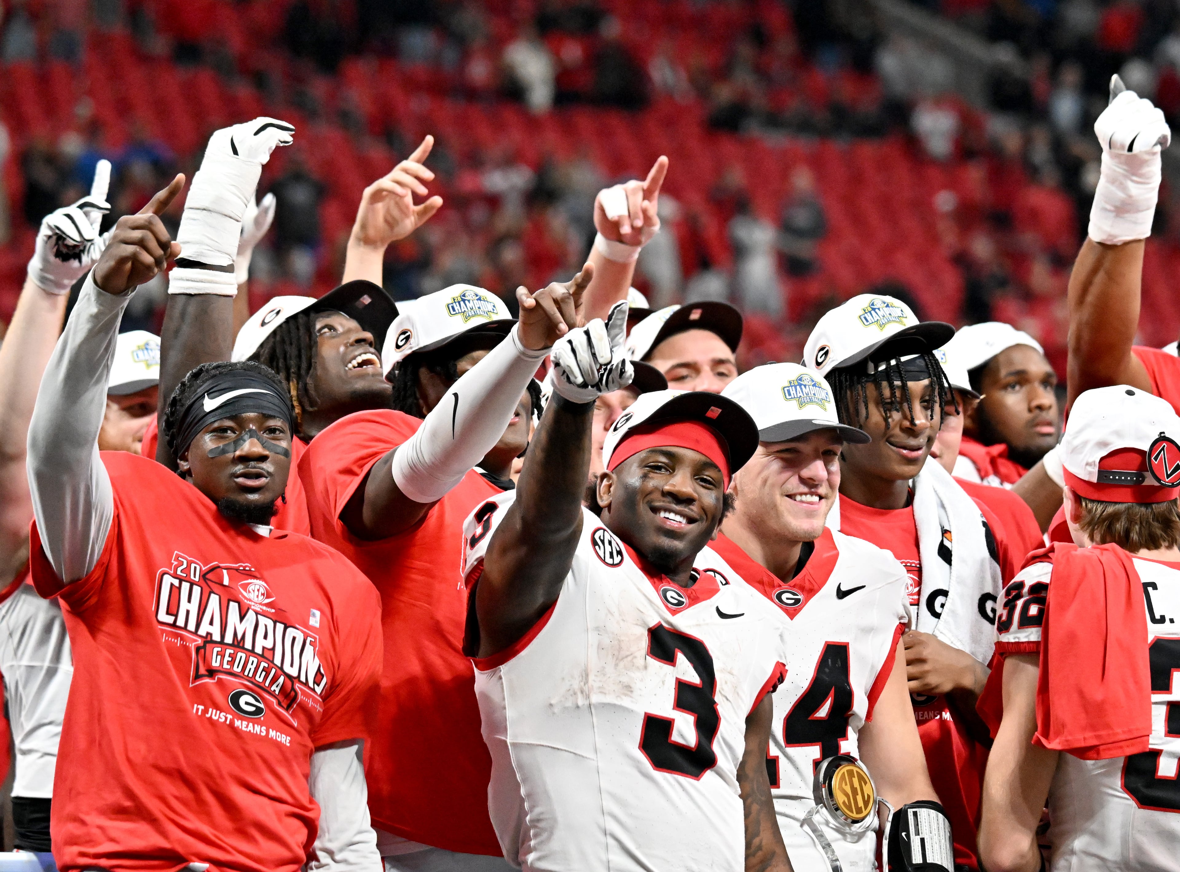 Georgia players celebrate after defeating Alabama 28-7 in the SEC Championship football game at the Mercedes-Benz Stadium, Saturday, December 6, 2025 in Atlanta. (Hyosub Shin / AJC)