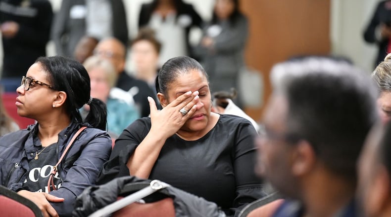 Andrea Stewart wipes away tears after speaking to the audience during a town hall meeting on conditions at the Cobb County Adult Detention Center. Credit: Hyosub Shin/The Atlanta Journal-Constitution