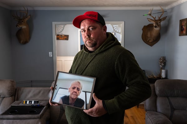 Charles Ingram holds a picture of his mother, Donna Nguyen, at his home in Newnan on Friday, Nov. 28, 2025. He lives in Coweta County now, but says he welcomes the improvements in the county where he was raised. (Arvin Temkar/AJC)