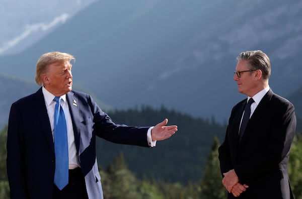 U.S. President Donald Trump, left, and Britain's Prime Minister Keir Starmer attend a family photo session during the G7 Summit, in Kananaskis, Alberta, Monday, June 16, 2025. (Suzanne Plunkett/Pool Photo via AP)