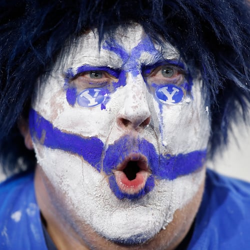 A BYU fan cheers during the second half of an NCAA college football game against TCU Saturday, Nov. 15, 2025, in Provo, Utah. (AP Photo/George Frey)