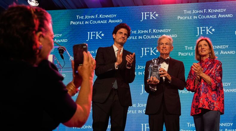 Federal Reserve Board Governor Jerome Powell, the former Federal Reserve chair, center, stands with former ambassador Caroline Kennedy, right, and her son Jack Schlossberg, as Powell's wife Elissa Leonard takes a picture at left, while being honored with the Profile in Courage Award at the John F. Kennedy Presidential Library, Sunday, May 31, 2026, in Boston. (AP Photo/Charles Krupa)
