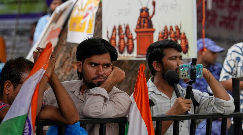 Supporters listen to a speaker during a protest by the Cockroach Janta Party demanding the resignation of Education Minister Dharmendra Pradhan over alleged examination irregularities and repeated paper leaks, in New Delhi, India, on July 10, 2026. (AP Photo/Manish Swarup)