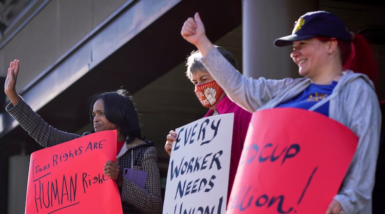 People gather outside the Ansley Mall Starbucks holding signs on the first day of a national strike Thursday, November 16th, 2023 (Ben Hendren for the Atlanta Journal-Constitution)