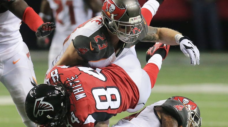 110115 ATLANTA: — Falcons wide reciever Roddy White is leveled as he makes a first down catch against the Buccaneers during the second half in a football game on Sunday, Nov. 1, 2015, in Atlanta. The Falcons were defeated 23-20 by the Buccaneers in over time. Curtis Compton / ccompton@ajc.com
