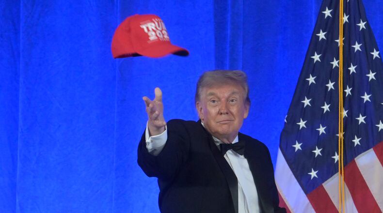 President Donald Trump tosses a "Trump 2028" hat at the White House Correspondents' Association dinner at the Waldorf Astoria Washington DC, Friday, July 24, 2026, in Washington. (AP Photo/Rod Lamkey, Jr.)