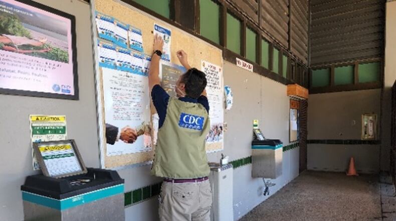 EIS officer Daniel Nguyen hangs up a recruitment flyer for the follow-up survey investigating ongoing health effects related to the jet fuel contamination of the Joint Base Pearl Harbor Hickam water system at a local community center in September 2022. PROVIDED BY CDC