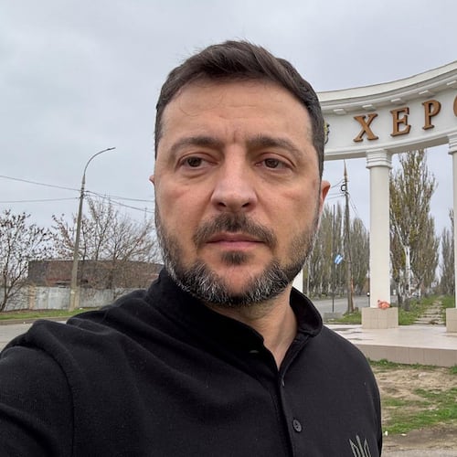 In this photo provided by the Ukrainian Presidential Press Office, Ukrainian President Volodymyr Zelenskyy stands at the sign reading "Kherson" at the approaches to the front line city of Kherson, Southern Ukraine, Tuesday, Nov. 11, 2025. (Ukrainian Presidential Press Office via AP)