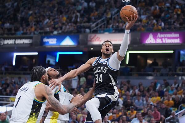 Milwaukee Bucks forward Giannis Antetokounmpo (34) shoots over Indiana Pacers center Myles Turner (33) during the first half of a first-round NBA basketball playoff game in Indianapolis, Tuesday, April 22, 2025. (AP Photo/Michael Conroy)