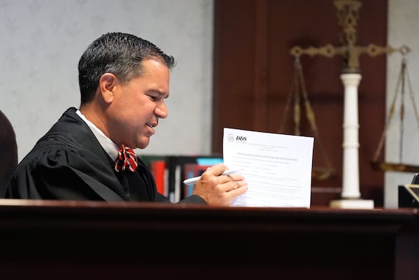 Judge Jason B. Thompson holds up a piece of paper during comedian and actor Tiffany Haddish’s court appearance via Zoom Tuesday, Aug. 11, 2026, in Fayetteville, Ga. (Brynn Anderson/AP)