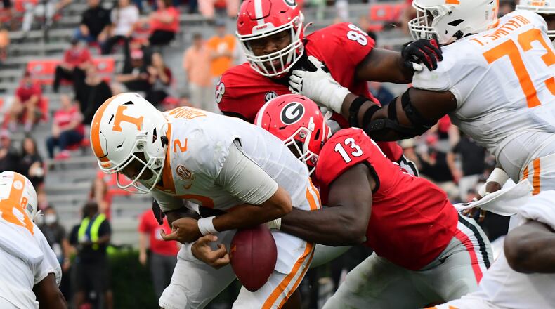 Georgia outside linebacker Azeez Ojulari (13) strips the ball from Tennessee quarterback Jarrett Guarantano on Saturday, Oct. 10, 2020, in Athens. (Perry McIntyre/UGA Sports)