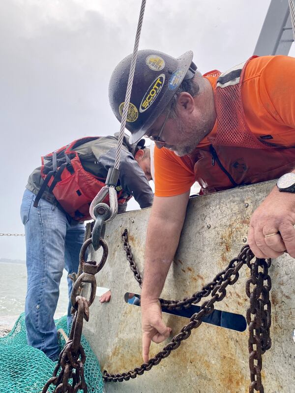 Wynn Gale, captain of the Big Cobb, wrangles a net used to survey for shrimp.
