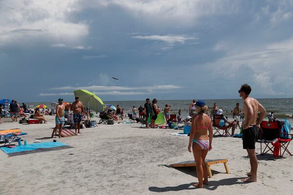 Beach goers play cornhole as they enjoy the Labor Day weekend on Tybee Island.
