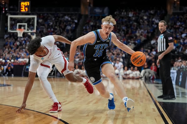 Brigham Young forward Richie Saunders (15) drives against Alabama forward Mouhamed Dioubate (10) during the second half of a Sweet 16 round NCAA college basketball tournament game, Thursday, March 27, 2025, in Newark, N.J. (AP Photo/Frank Franklin II)