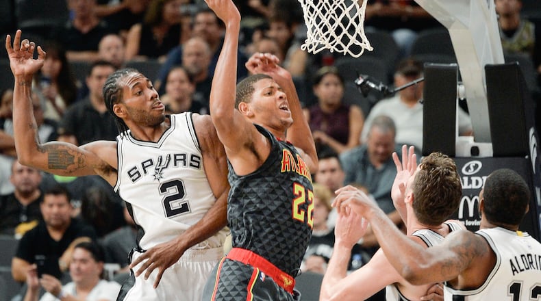 Atlanta Hawks center Walter “Edy” Tavares (22) tangles with San Antonio Spurs’ Kawhi Leonard (2), Pau Gasol, of Spain, and LaMarcus Aldridge, right, during the first half of a preseason NBA basketball game, Saturday, Oct. 8, 2016, in San Antonio. (AP Photo/Darren Abate)