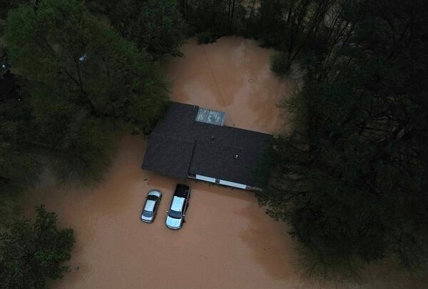 Floodwaters inundate homes and vehicles in Shannon Hills, Ark., Saturday, April 5, 2025 as a second day of storms brought widespread flooding to the region. (Colin Murphey/Arkansas Democrat-Gazette via AP)
