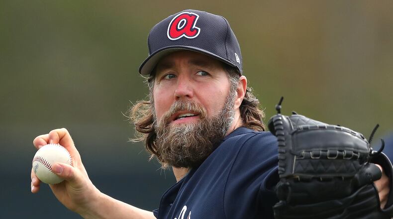 Veteran knuckleballer R.A. Dickey threw off a mound Wednesday in the first workout for Braves pitchers and catchers. (Curtis Compton/ccompton@ajc.com)