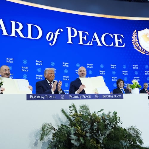 FILE - President Donald Trump, center, applauds as Ilham Aliyev, President of Azerbaijan, left, and Bulgaria's Prime Minister Rossen Jeliazkov, right, hold up their signed Board of Peace charter during the Annual Meeting of the World Economic Forum in Davos, Switzerland, Jan. 22, 2026. (AP Photo/Evan Vucci, File)
