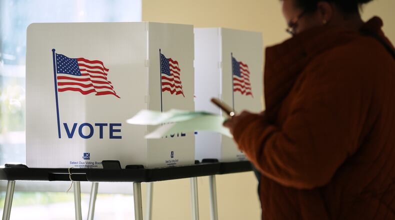 FILE - A person waits to cast a ballot at the Horatio Williams Foundation in downtown Detroit, Nov. 4, 2025. (AP Photo/Ryan Sun, File)
