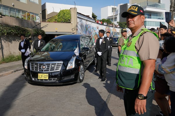A funeral hearse transports the coffin of Peruvian Nobel literature laureate Mario Vargas Llosa to a crematorium in Lima, Peru, Monday, April 14, 2025. (AP Photo/Martin Mejia)
