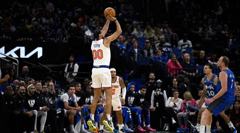 New York Knicks forward Jacob Toppin (00) shoots a 3-pointer during the second half of an NBA basketball game against the Orlando Magic, Wednesday, Feb. 14, 2024, in Orlando, Fla. (AP Photo/Phelan M. Ebenhack)