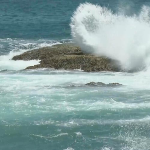 In this image made from video, waves crash on rocks ahead of Typhoon Bavi along the coast of Keelung in northern Taiwan on Thursday, July 9, 2026. (AP Photo/Taijing Wu)