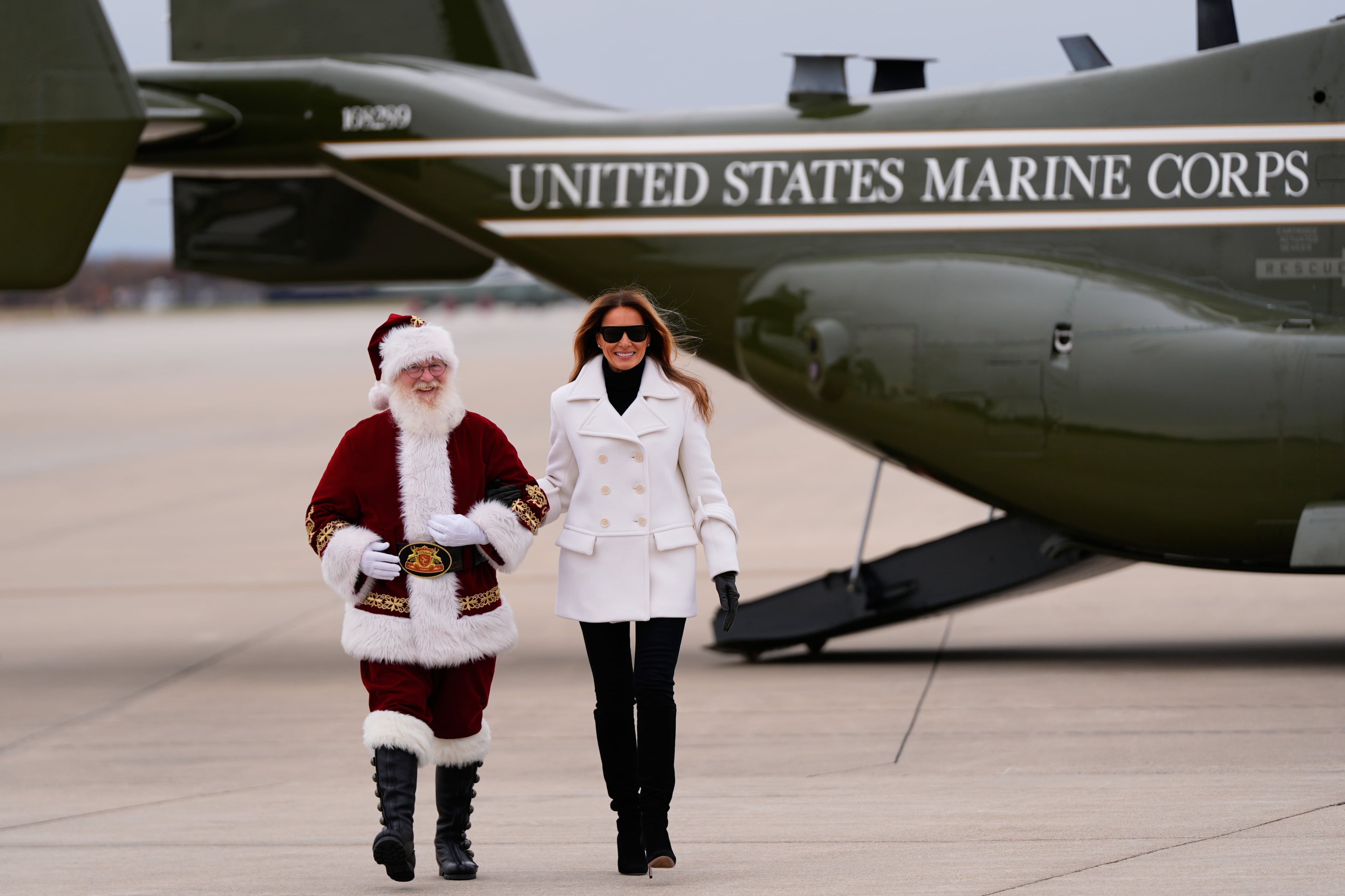 First lady Melania Trump arrived with Santa Claus at Marine Corps Base Quantico in Virginia for a Toys for Tots charity event on Monday. (Julia Demaree Nikhinson/AP)