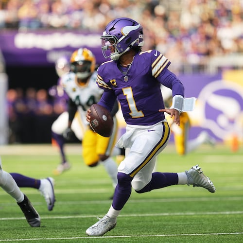 Minnesota Vikings quarterback Kyler Murray (1) scrambles under pressure from Green Bay Packers linebacker Edgerrin Cooper (56) during the first half of an NFL football game, Sunday, Sept. 13, 2026, in Minneapolis, Minn. (AP Photo/Bailey Hillesheim)